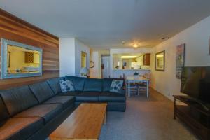 a living room with a blue couch and a table at The Bridges 102 in Mammoth Lakes