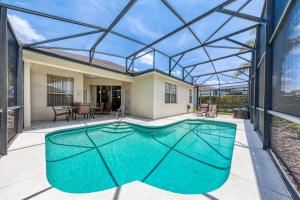 an indoor swimming pool in a house with a glass roof at Windstar Villa in Davenport