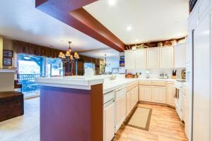 a large kitchen with white cabinets and a large island at Lazy on the Lakefront (F205) in Twin Beaches