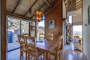 a dining room with a wooden table and chairs at Vista Grande in Sea Ranch