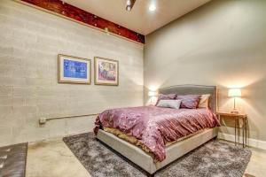 a bedroom with a bed with purple comforter at Bella Casa- Downstairs unit in Moab
