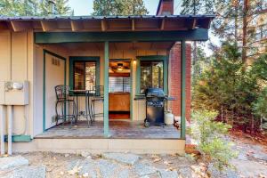 a small house with a grill on a deck at The Cottage in Shaver Lake