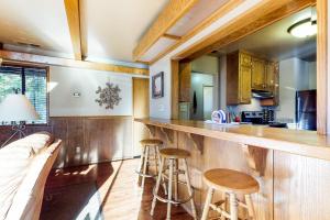 a kitchen with a bar with stools and a couch at The Cottage in Shaver Lake