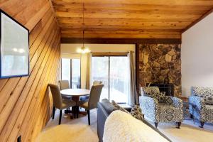 a living room with a table and chairs at Huntington Lake Condo 12 in Lakeshore