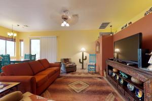 uma sala de estar com um sofá e uma televisão de ecrã plano em Rancho Vistoso #2677 em Catalina