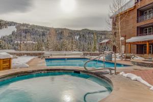 a large swimming pool in front of a building at The Dakota Outpost in Keystone