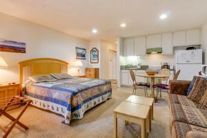 a bedroom with a bed and a table and a kitchen at St. Moritz 75 in Mammoth Lakes