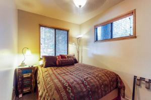 a bedroom with a bed and a window at The Cottage in Shaver Lake