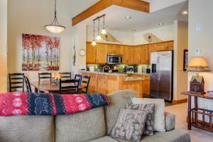 a living room with a couch and a kitchen at Lodestar Cabins in Mammoth Lakes