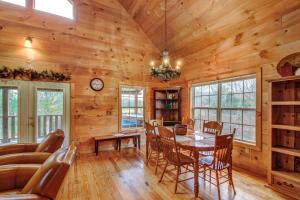 a dining room and living room in a log cabin at Twin Cub Lodge in Lawson Crossroad