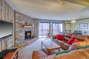 a living room with a couch and a fireplace at Mammoth Ski & Racquet 124 in Mammoth Lakes
