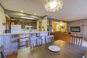 a dining room and kitchen with a table and chairs at Mammoth Ski & Racquet 124 in Mammoth Lakes