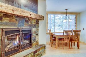 a fireplace in a dining room with a table and chairs at Lake Tahoe Serenity in Kingswood Estates