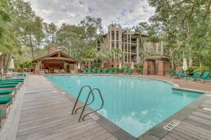 a swimming pool with chairs and a building at 6002 Maritime Villa in Kiawah Island