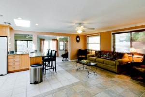 a living room with a couch and a kitchen at Tropical Oasis in Anna Maria