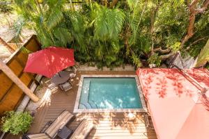 an overhead view of a swimming pool with a red umbrella at Casa Atlantic in Key West