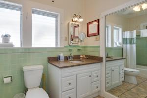 a bathroom with a sink and a toilet and a mirror at Tradewinds in Key West +36 photos