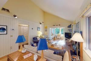 a living room with a couch and a table at Oceanwoods 443 in Kiawah Island