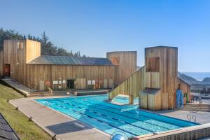 a house with a swimming pool in front of a building at Rolling Waves Beach House in Sea Ranch