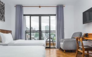Postel nebo postele na pokoji v ubytování Phnom Penh 51 Hotel & Residences
