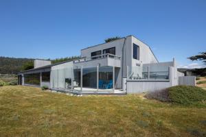 a house on a hill with a grass field at Rolling Waves Beach House in Sea Ranch