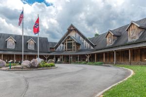 a large wooden building with two flags in front of it at Cabin Fever in Townsend