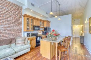 a living room with a couch and a kitchen at Savannah Serendipity in Savannah