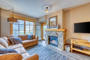 a living room with a fireplace and a tv at Passage Point 207 in Copper Mountain