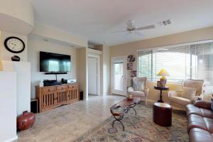 a living room with a couch and a flat screen tv at Rancho Vistoso #226C in Tortolita