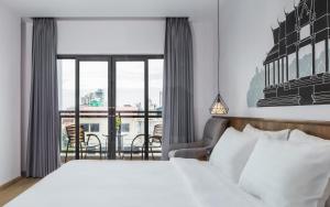 Postel nebo postele na pokoji v ubytování Phnom Penh 51 Hotel & Residences