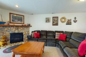 a living room with a couch and a fireplace at Tennis Court Condo in Garden City