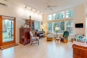 a living room filled with furniture and a piano at Saratoga Passage Bungalow in Baby Island Heights