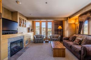 a living room with a couch and a fireplace at Shoshone 1954 in Big Sky
