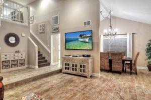 a living room with a tv and a dining table at North Beach C in San Clemente