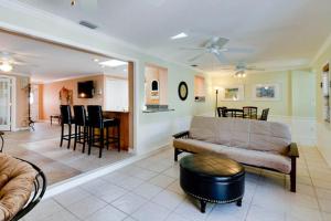 a living room with a couch and a table at Tropical Oasis in Anna Maria