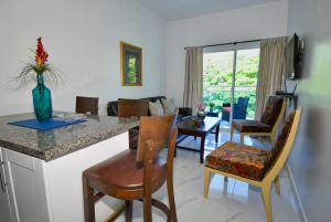 a kitchen and living room with a table and chairs at Rosil Place in San Felipe de Puerto Plata
