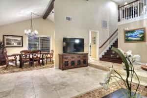 a living room with a television and a dining room at North Beach A in San Clemente