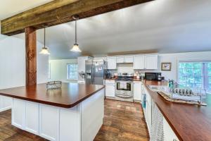 a kitchen with white cabinets and a wooden counter top at Pine's Way Camp in Chestertown