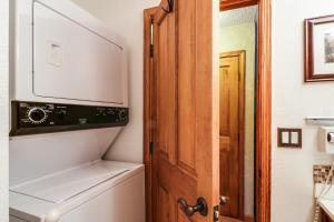 a bathroom with a toilet and a wooden door at Saxon Creek in Mevers +16 photos
