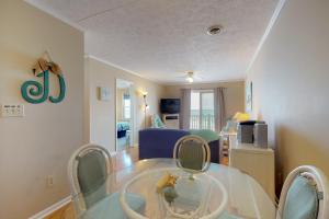 a living room with a glass table and chairs at Best Beach Spot in Myrtle Beach