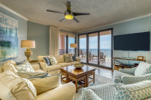 a living room with couches and a flat screen tv at Four Seasons 501W in Orange Beach