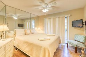 a bedroom with a large bed and a mirror at Seagrove Beach - Beachwood Villas 12D in Santa Rosa Beach +19 photos