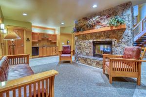 a large living room with a stone fireplace at Copper Mountain Ski Hideaway in Copper Mountain