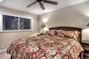 a bedroom with a bed and a ceiling fan at North Beach A in San Clemente