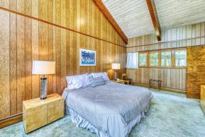 a bedroom with a bed in a room with wooden walls at Private Contemporary in Chestertown