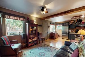 a living room with a couch and a kitchen at Get Away From It All in Pine Glen