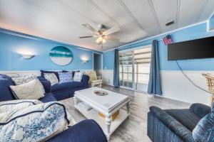 a living room with a couch and a table at Oyster Lane Hideout in Ocean City