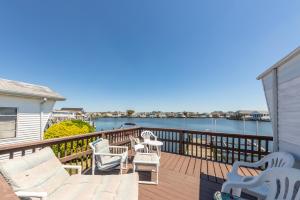 a deck with chairs and a view of the water at Oyster Lane Hideout in Ocean City
