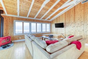 a living room with a large couch and a television at 37 Ocean Bay Blvd in Ocean Bay Park