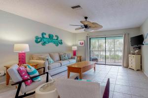 a living room with a couch and a table at Pelican Cove 6 in Bradenton Beach